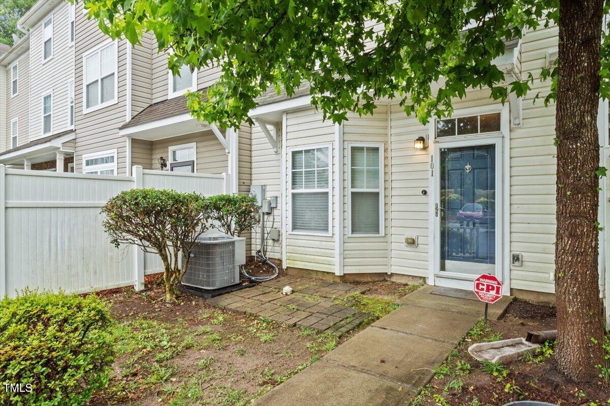 300 Gilman Lane, Unit 101 Raleigh, NC 27610 - Photo 3 of 25 a front view of a house with a garden