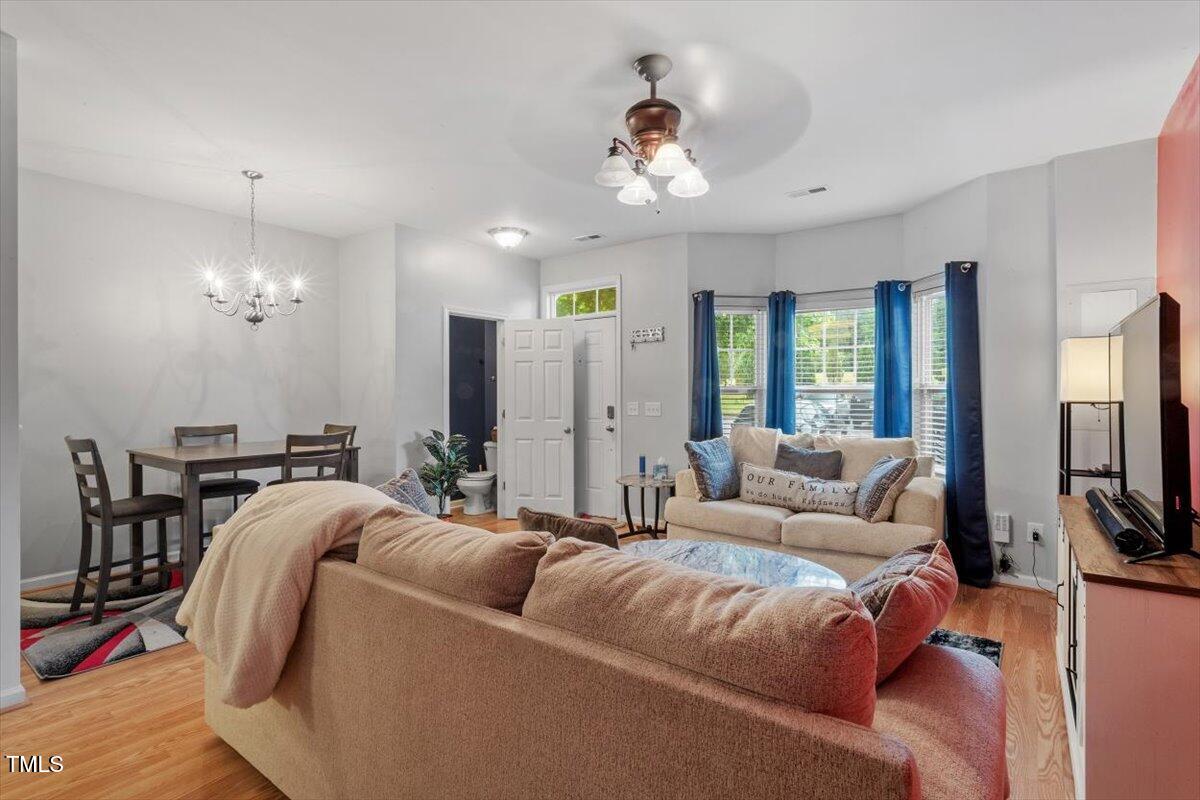 300 Gilman Lane, Unit 101 Raleigh, NC 27610 - Photo 5 of 25 a living room with furniture a large window and a flat screen tv