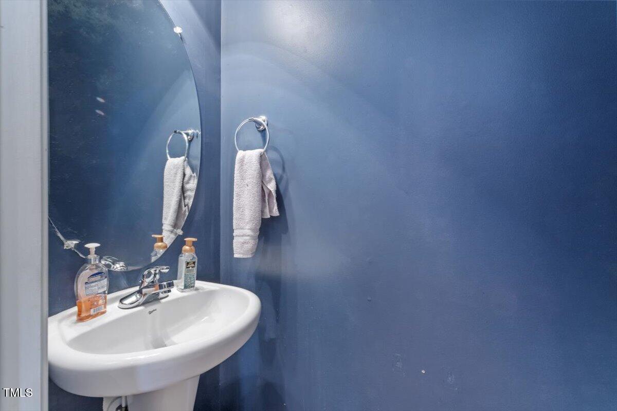 300 Gilman Lane, Unit 101 Raleigh, NC 27610 - Photo 8 of 25 a bathroom with a sink and a mirror
