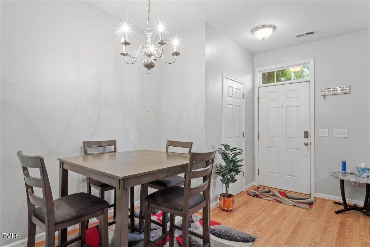 300 Gilman Lane, Unit 101 Raleigh, NC 27610 - Photo 10 of 25 a view of a dining room with furniture and wooden floor