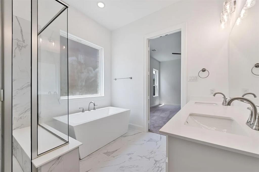 9337 Loggerhead Way Fort Worth, TX 76118 - Photo 28 of 40 a bathroom with a sink and mirror with bathtub