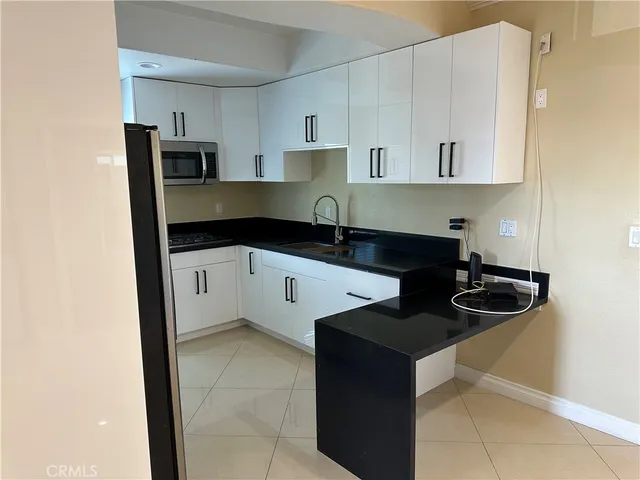 a kitchen with stainless steel appliances granite countertop a sink and a stove