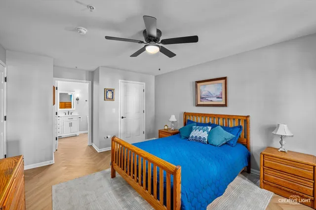 a bedroom with a bed and a chandelier