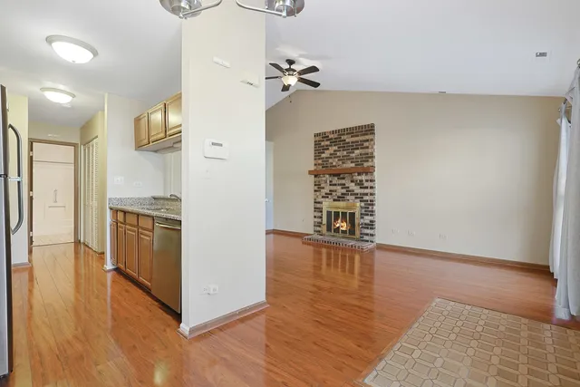 a view of a kitchen with furniture and wooden floor