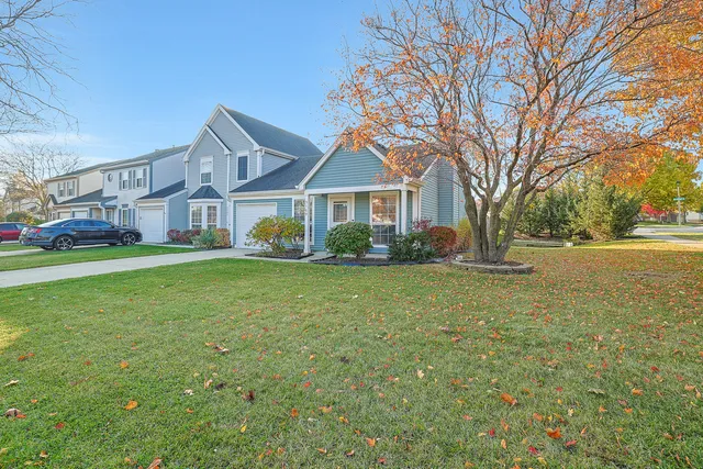 a front view of house with yard and green space