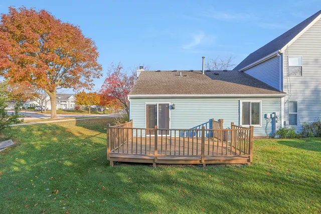 a view of a house with a yard and deck