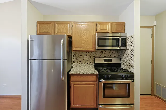 a kitchen with a refrigerator stove and microwave