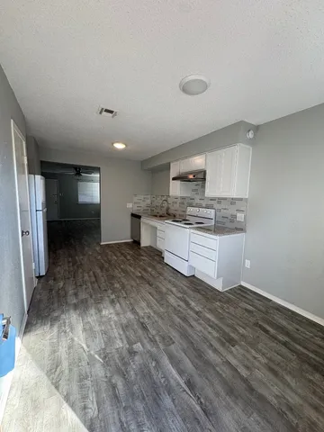 a kitchen with stainless steel appliances a refrigerator and a stove top oven
