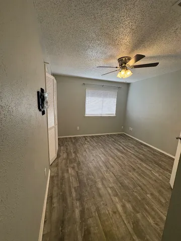 a view of room with a ceiling fan and window