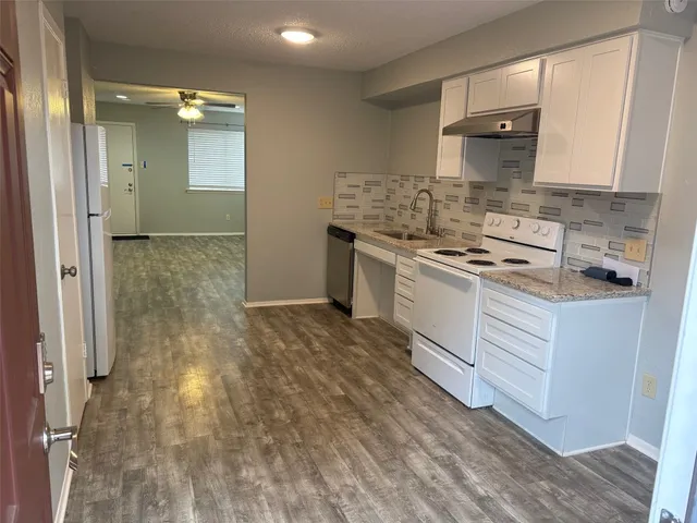 a kitchen with a sink stove and cabinets