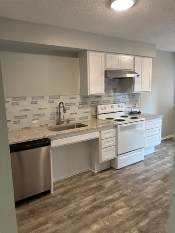 a kitchen with a sink stove and cabinets