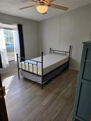 a bed sitting in a room next to a window