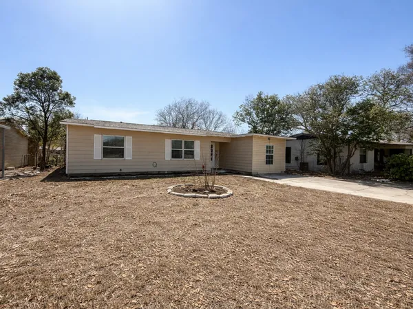 a backyard of a house with table and chairs