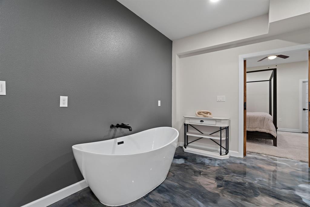 5410 Buffalo Ridge Drive, Unit L Stephenville, TX 76401 - Photo 18 of 40 a bathroom with a bathtub and shower