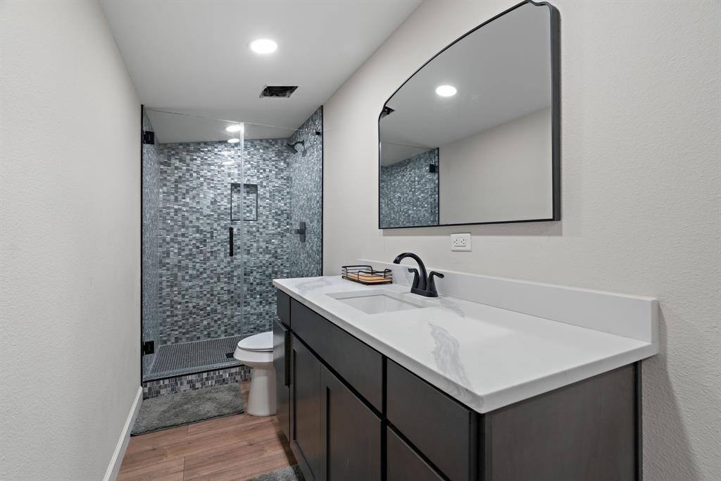 5410 Buffalo Ridge Drive, Unit L Stephenville, TX 76401 - Photo 23 of 40 a bathroom with a sink toilet vanity and shower