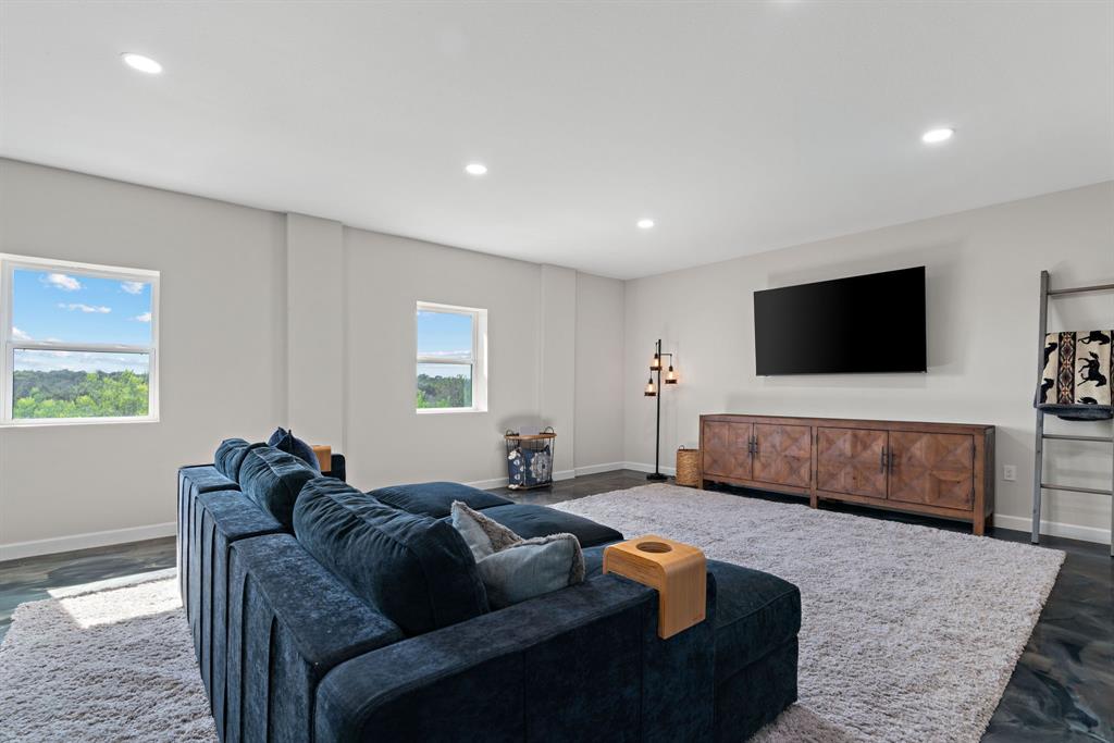 5410 Buffalo Ridge Drive, Unit L Stephenville, TX 76401 - Photo 6 of 40 a living room with furniture and a flat screen tv