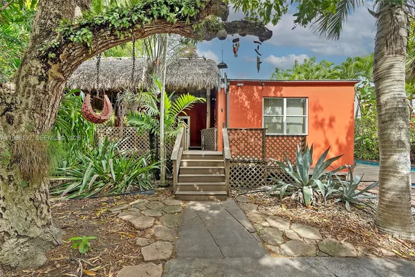 a living room with furniture fireplace and large windows
