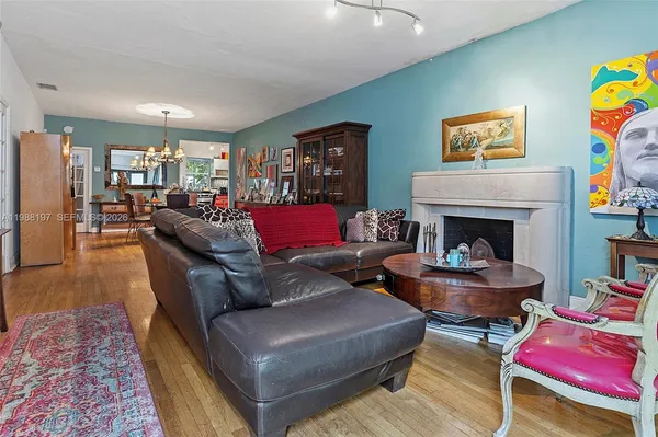 a view of a dining room with furniture a chandelier and wooden floor