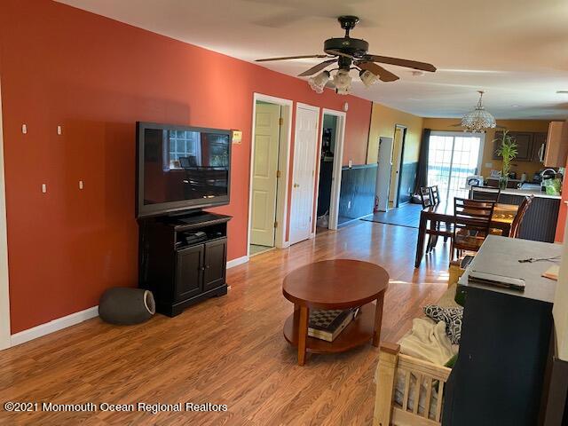 65 9th Street Belford, NJ 07718 - Photo 5 of 10 a kitchen with granite countertop a stove a refrigerator a dining table and chairs with wooden floor