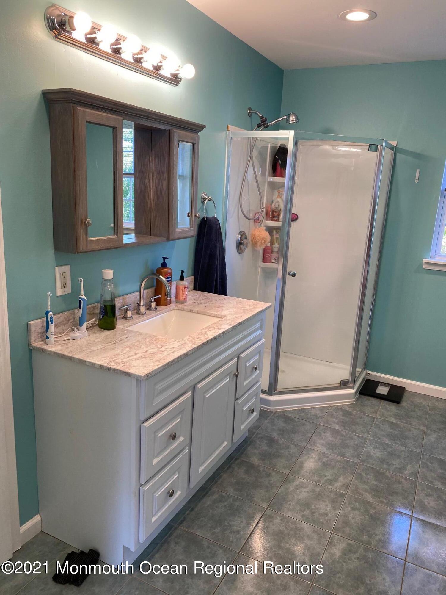 65 9th Street Belford, NJ 07718 - Photo 6 of 10 a bathroom with a sink and a mirror