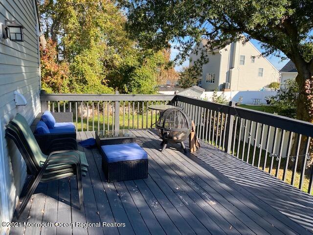 65 9th Street Belford, NJ 07718 - Photo 7 of 10 a view of balcony with wooden floor and outdoor seating