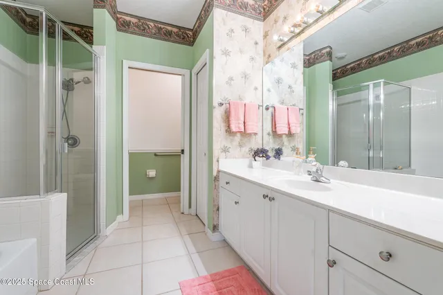 a view of a lake with a yard and large trees