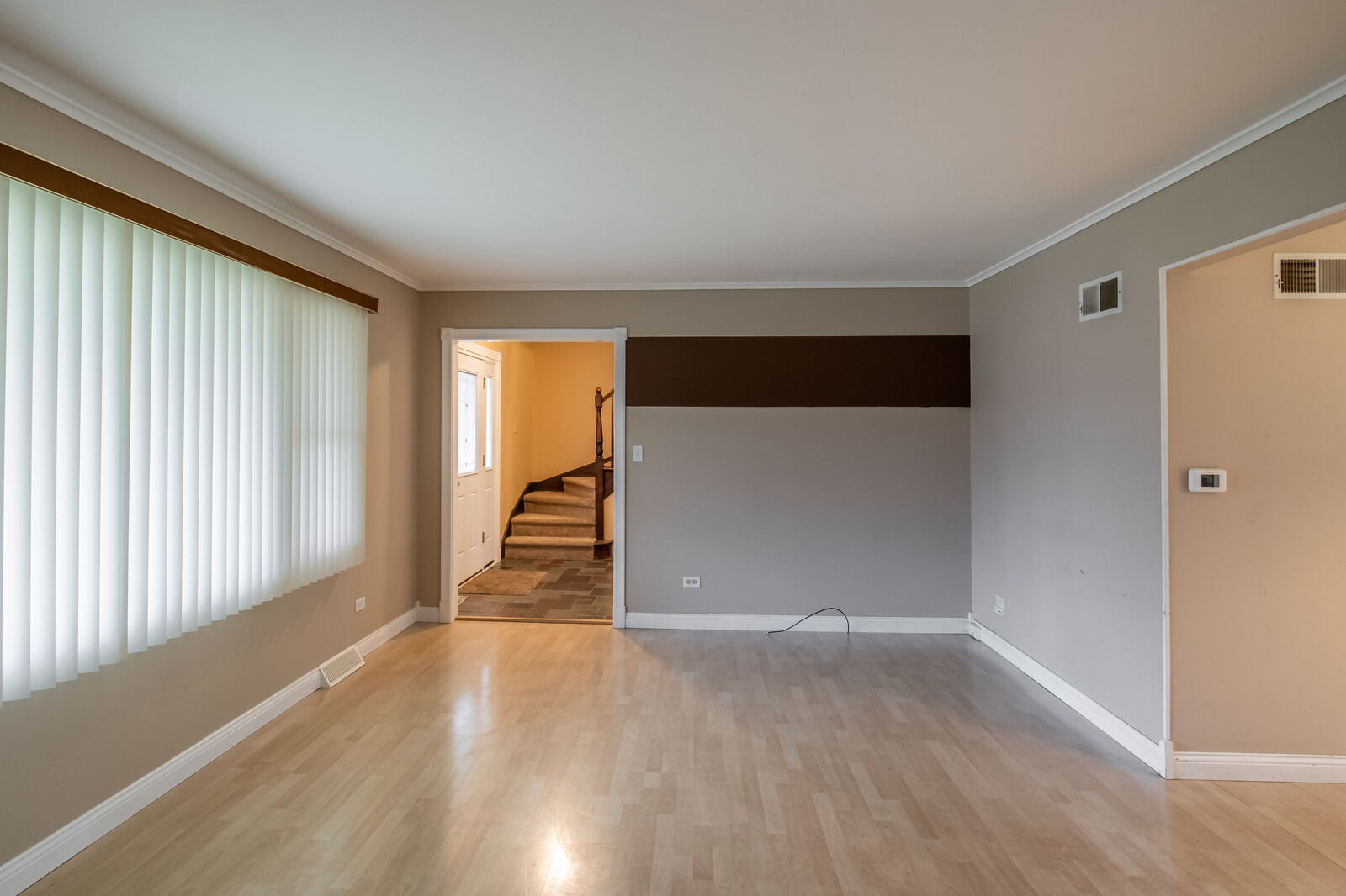2321 Beck Road Lindenhurst, IL 60046 - Photo 3 of 30 an empty room with wooden floor and windows