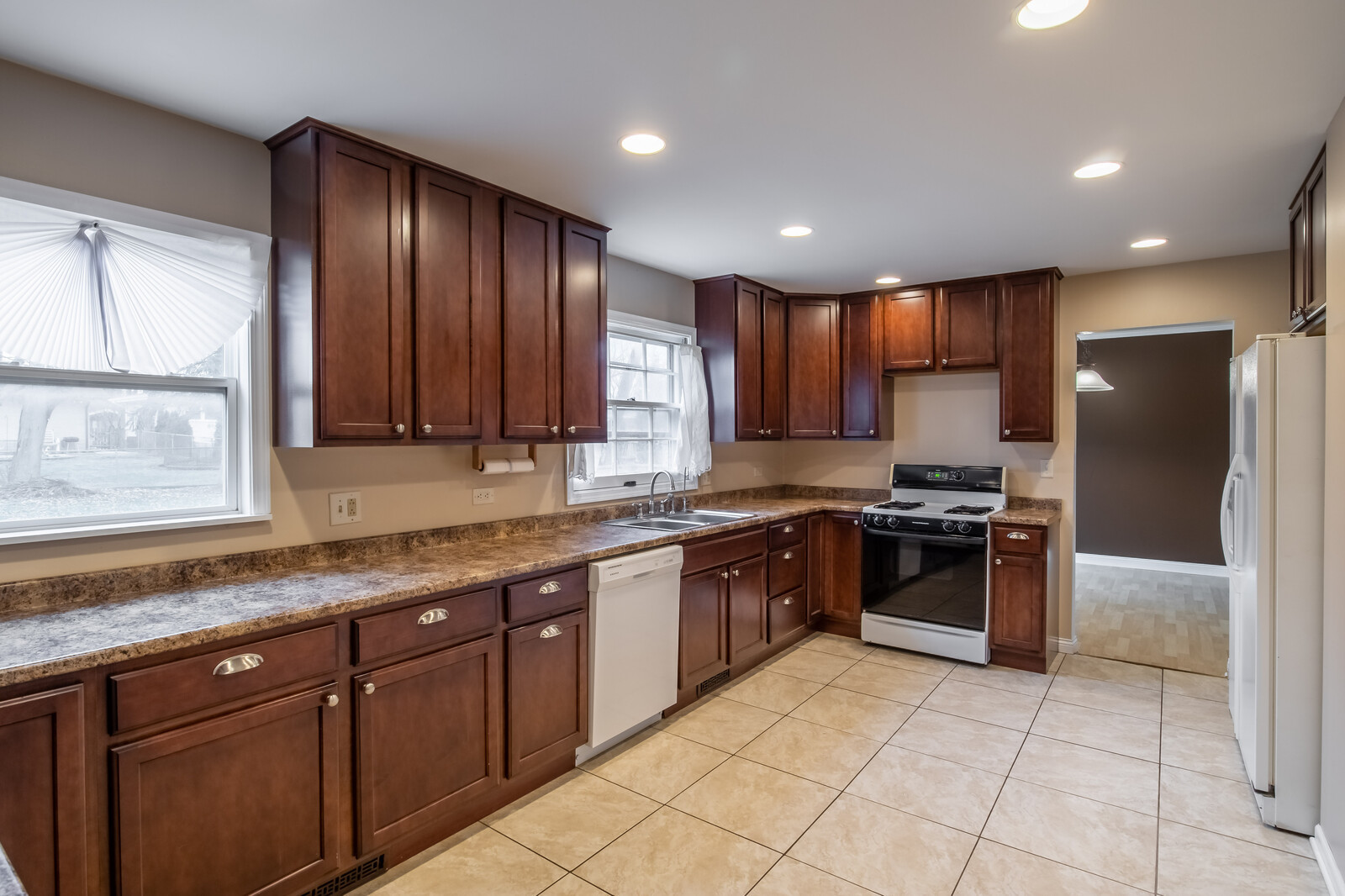 2321 Beck Road Lindenhurst, IL 60046 - Photo 8 of 30 a large kitchen with granite countertop stainless steel appliances a stove sink and cabinets