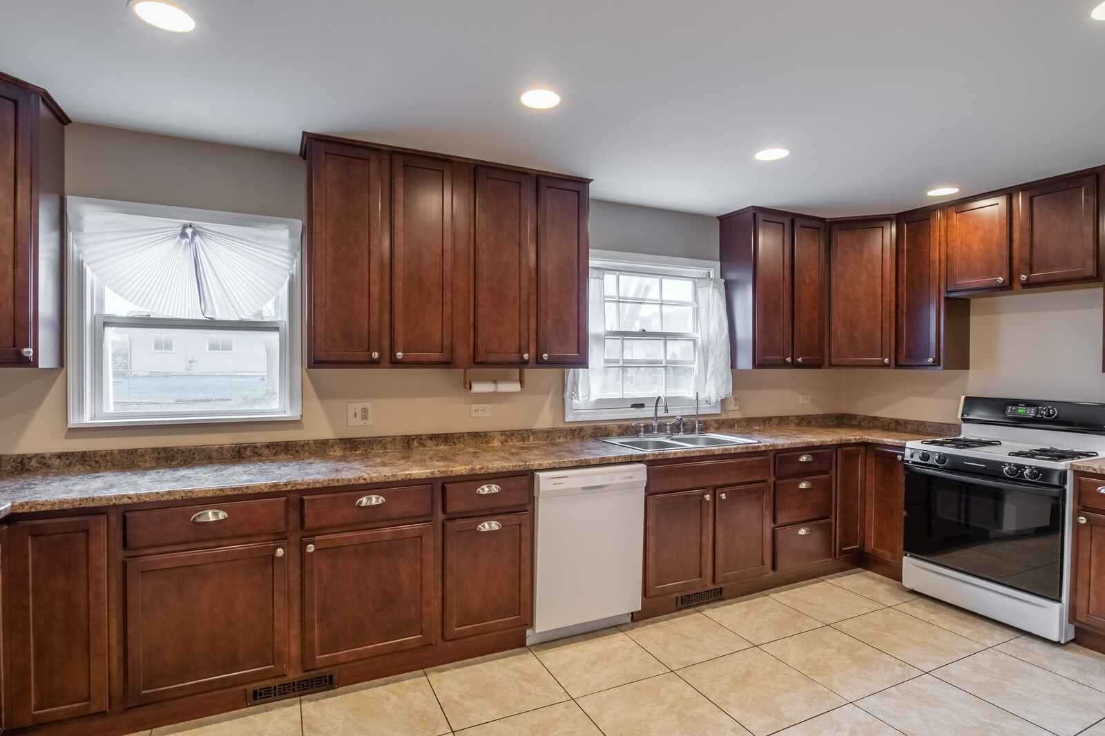 2321 Beck Road Lindenhurst, IL 60046 - Photo 9 of 30 a kitchen with stainless steel appliances granite countertop wooden cabinets a sink and dishwasher a stove a refrigerator with wooden cabinets