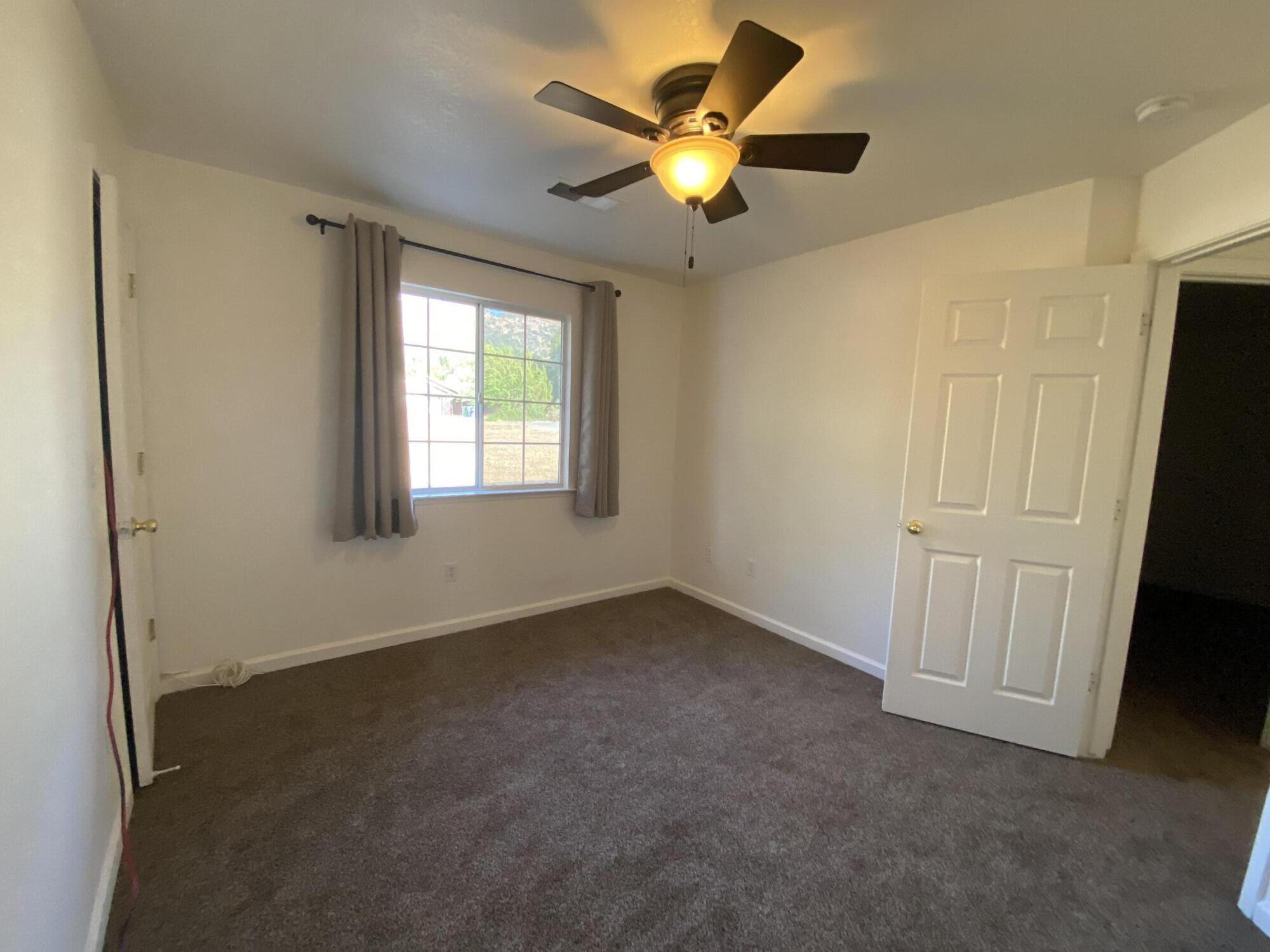 40855 Grouse Drive Three Rivers, CA 93271 - Photo 18 of 24 an empty room with a window and a fan
