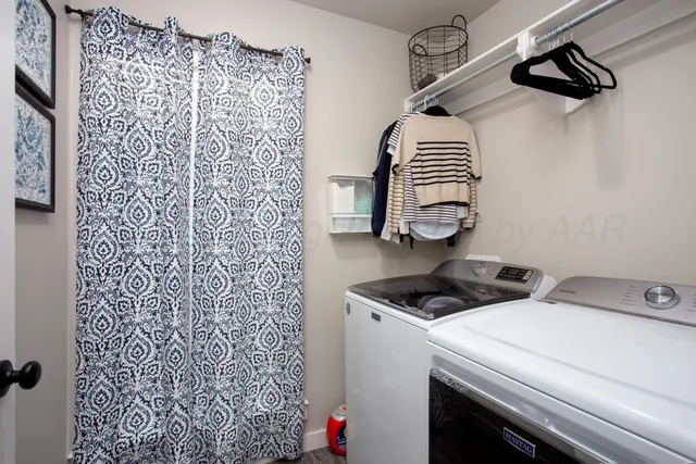 a bathroom with a shower curtain and a sink