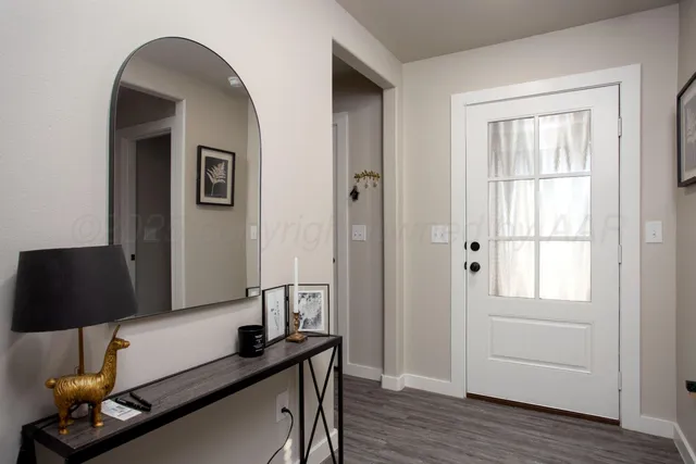 a view of a workspace room with wooden floor and cabinet