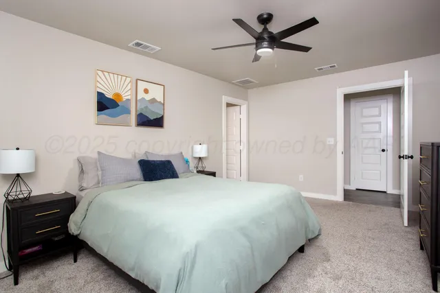 a bedroom with a bed and a ceiling fan
