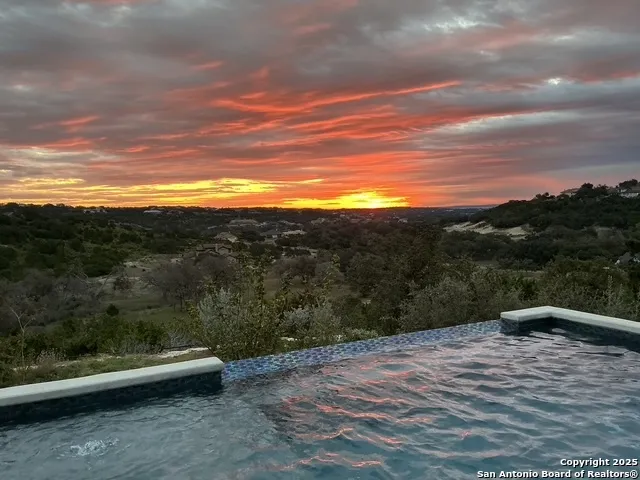 an aerial view of a house with garden space and street view
