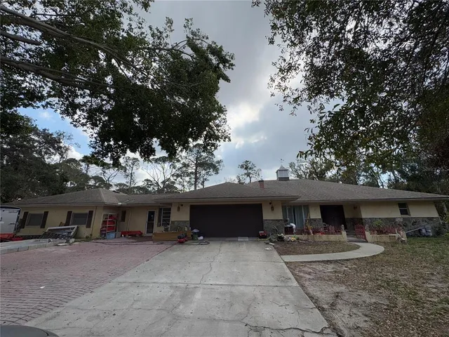 a backyard of a house with table and chairs