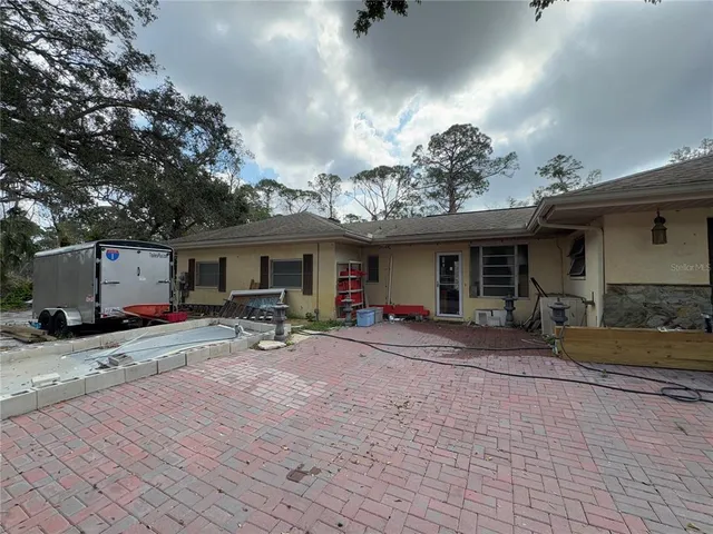 a view of a swimming pool with an outdoor seating