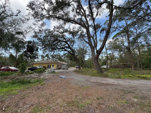a view of a house with backyard and sitting area