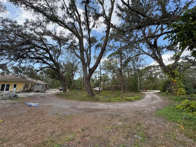a view of a patio with table and chairs under an umbrella