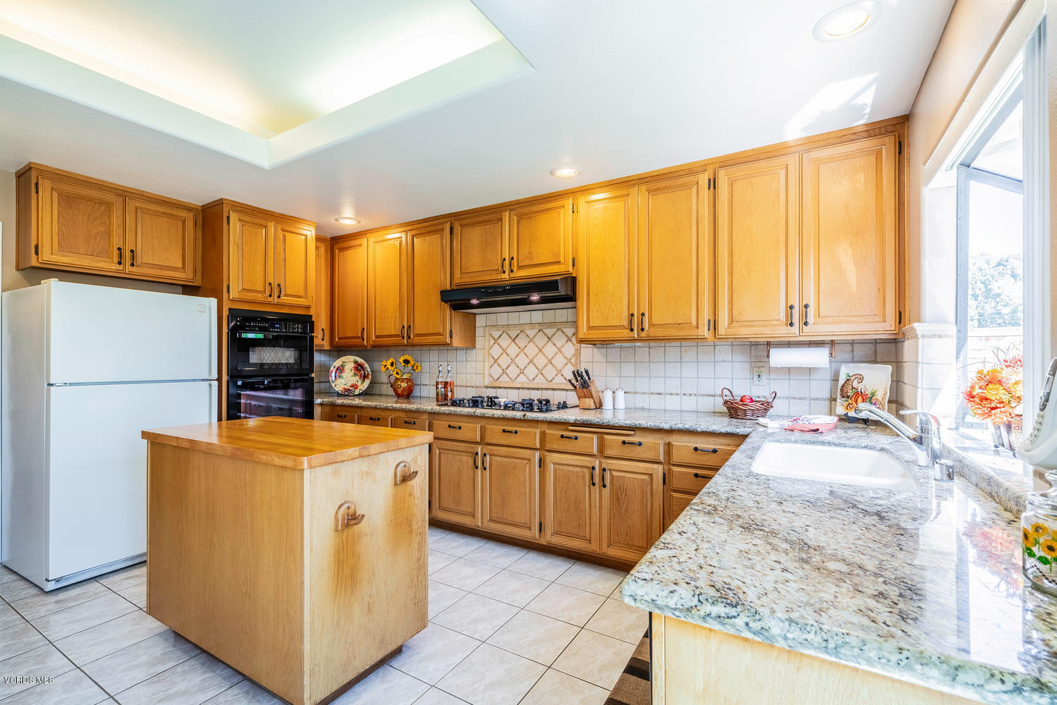 34 South Madrid Avenue Newbury Park, CA 91320 - Photo 9 of 31 a kitchen with stainless steel appliances granite countertop a stove top oven a sink and a refrigerator