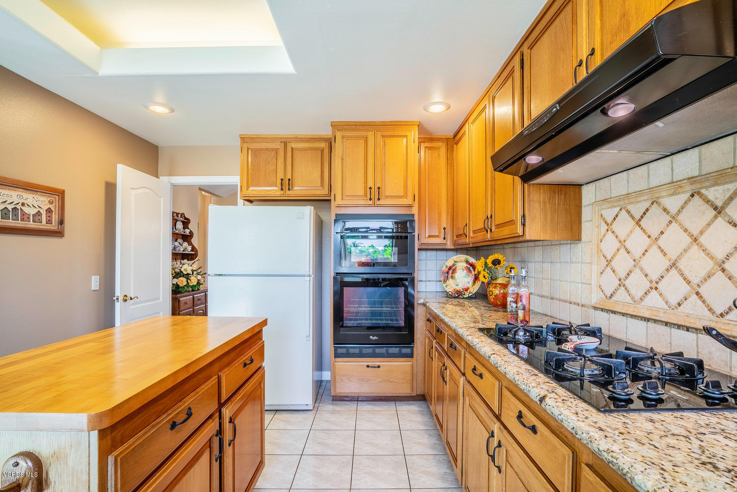 34 South Madrid Avenue Newbury Park, CA 91320 - Photo 10 of 31 a kitchen with stainless steel appliances a stove a sink and a refrigerator