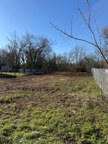 327 Houston Street Elgin, TX 78621 - Photo 2 of 5 a view of a field with an trees