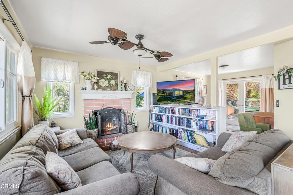 20176 South Mountain Road Santa Paula, CA 93060 - Photo 4 of 43 a living room with furniture a flat screen tv and a fireplace
