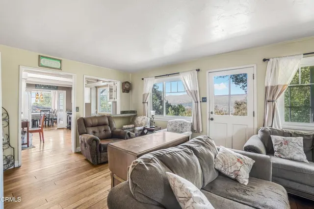 a living room with furniture ceiling fan and a window