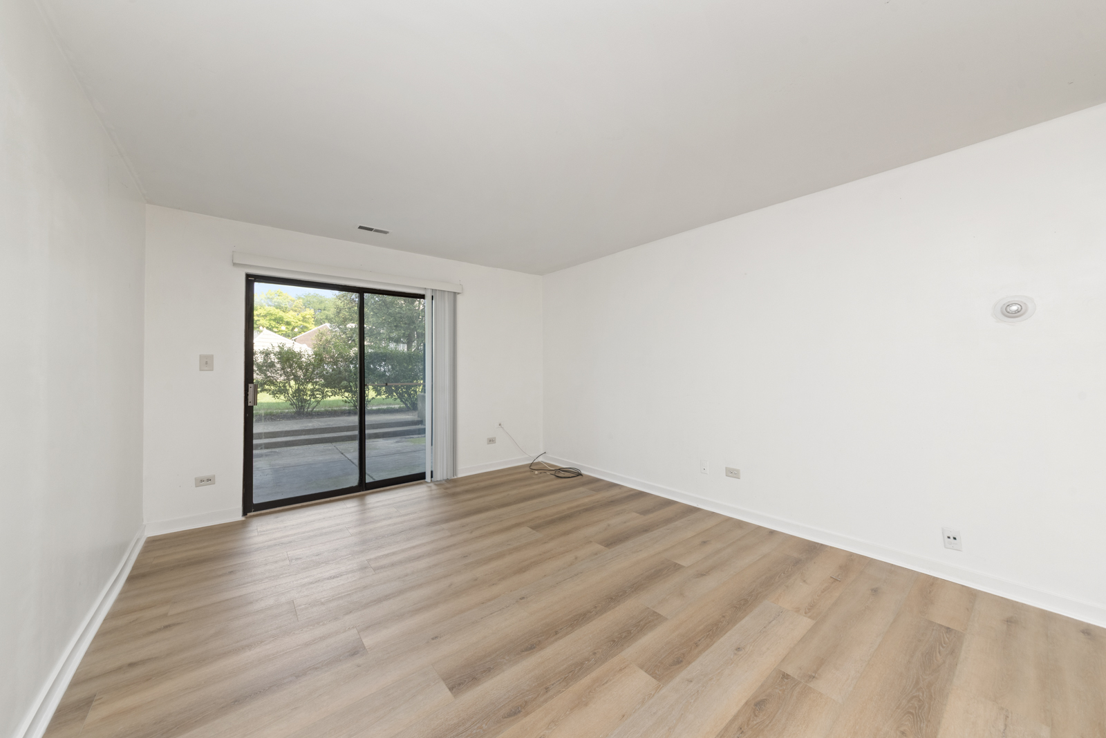 1420 Stonebridge Circle, Unit N3 Wheaton, IL 60189 - Photo 3 of 12 an empty room with wooden floor and windows