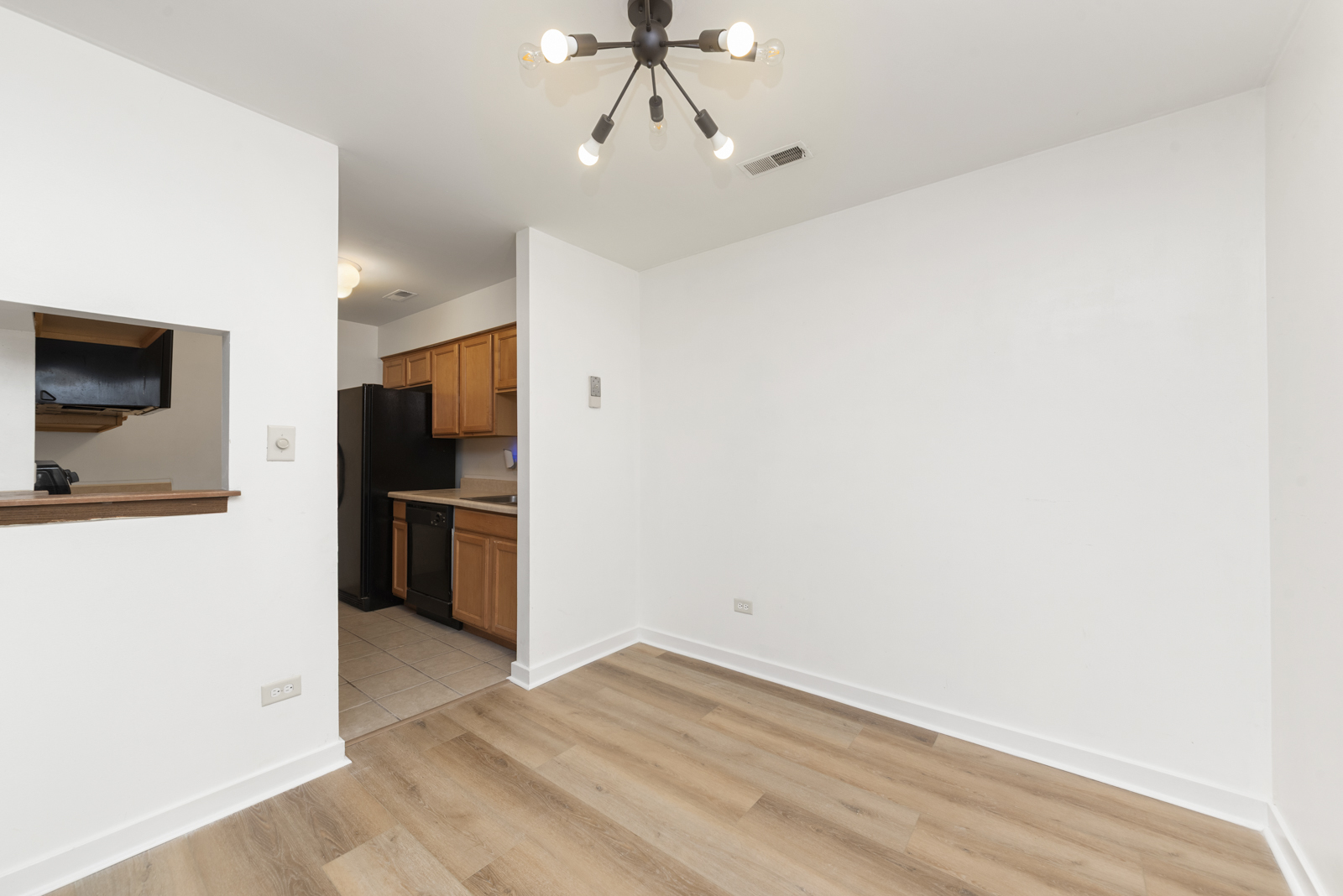 1420 Stonebridge Circle, Unit N3 Wheaton, IL 60189 - Photo 4 of 12 a view of a kitchen with a sink and a refrigerator