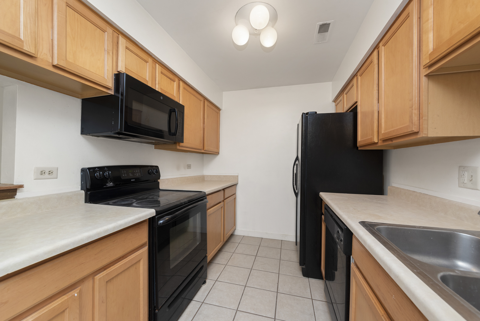 1420 Stonebridge Circle, Unit N3 Wheaton, IL 60189 - Photo 5 of 12 a kitchen with stainless steel appliances granite countertop a refrigerator a stove top oven a sink and dishwasher