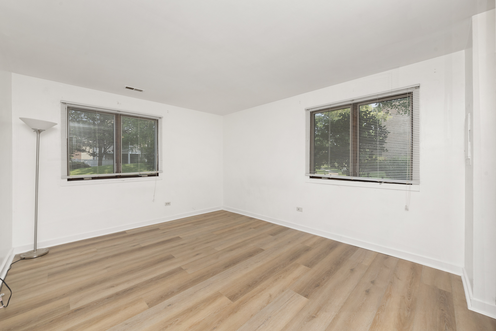 1420 Stonebridge Circle, Unit N3 Wheaton, IL 60189 - Photo 6 of 12 a view of an empty room with wooden floor and a window