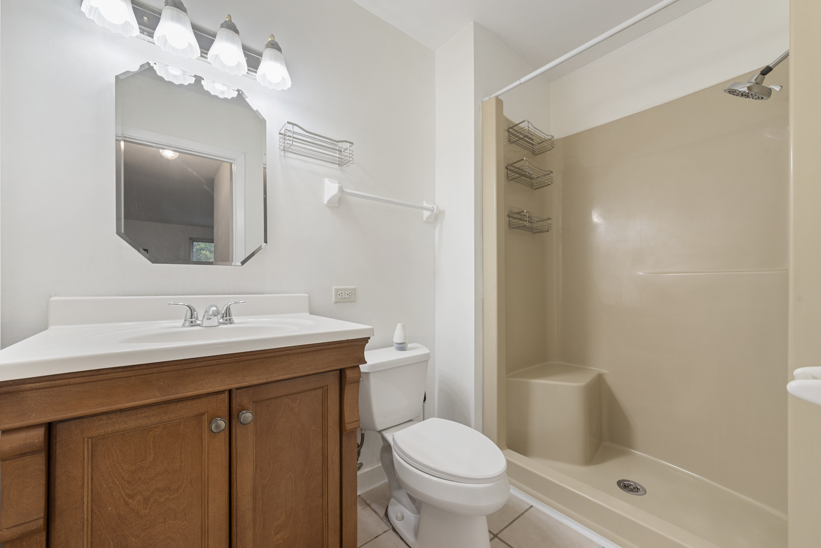 1420 Stonebridge Circle, Unit N3 Wheaton, IL 60189 - Photo 7 of 12 a bathroom with a sink a toilet and shower