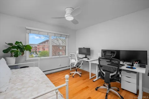 a view of a workspace with furniture and a window