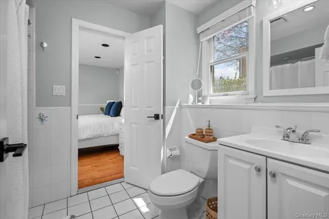 a bathroom with a sink a toilet and a mirror